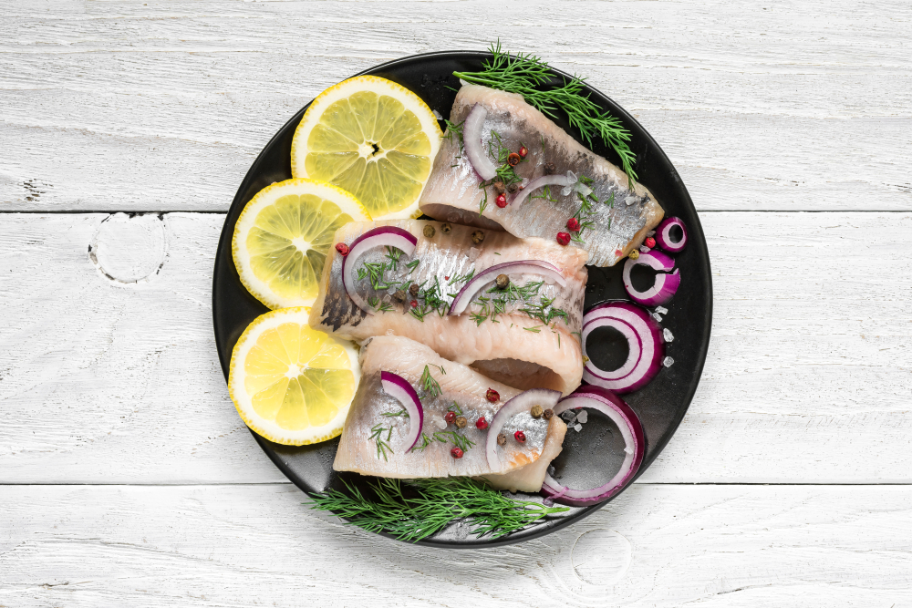 Herring,Fillet,With,Salt,,Pepper,,Herbs,,Onion,And,Lemon,On