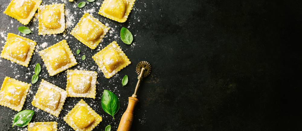 Tasty,Raw,Ravioli,With,Flour,And,Basil,On,Dark,Background.