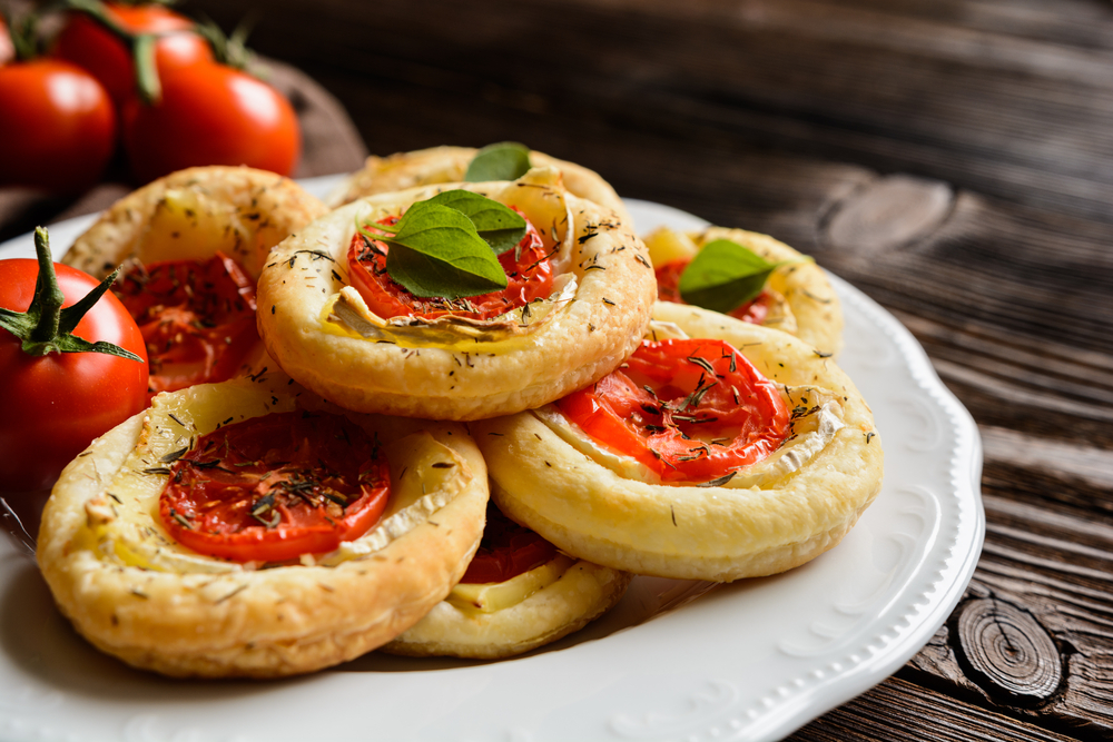 Small,Pizzas,With,Camembert,Cheese,,Tomato,And,Herbs