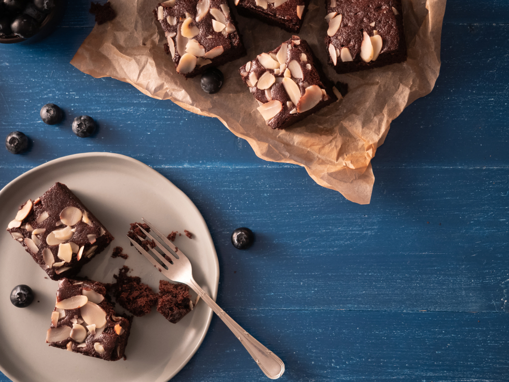 Homemade,Chocolate,Brownie,With,Almond,Slices,Topping,And,Blueberries,On